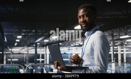 Smiling technician and colleague in data center reviewing large language model visualizations on PC. Happy IT engineering team analyzing neural network performance outputs Stock Photo
