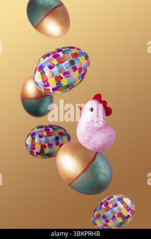 Easter eggs, toy chicken on a beige background, flying food Stock Photo