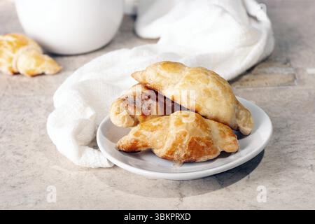 Puff pastry pies on a white ceramic plate Stock Photo
