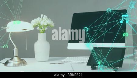 Showing monitor above keyboard on office desk, metallic pull-chain lamp, tablet and digital overlay Stock Photo