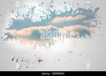 Splash on wall revealing blue sky Stock Photo