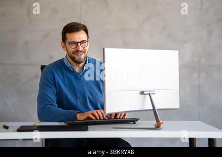 Happy professional business man company employee, young entrepreneur, smiling businessman working Stock Photo
