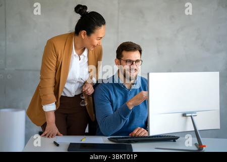 Mixed team of software engineers brainstorming ideas. Diverse app developers collaborating as group Stock Photo
