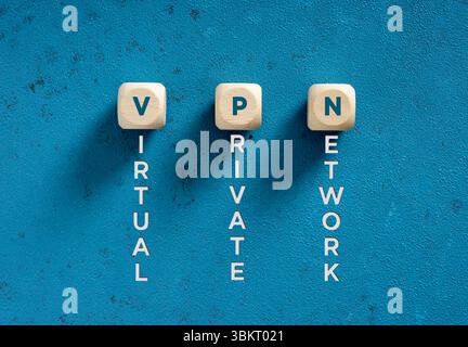 Wooden cubes spelling VPN acronym meaning virtual private network placed on blue textured background Stock Photo
