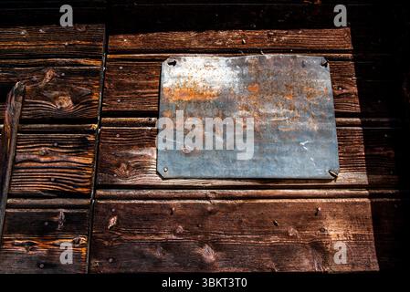 empty iron plaque on wooden door in San Martino di Castrozza Trento Italy Stock Photo