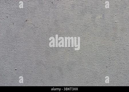 Light grey concrete or rendered stucco wall texture full frame background. Stock Photo