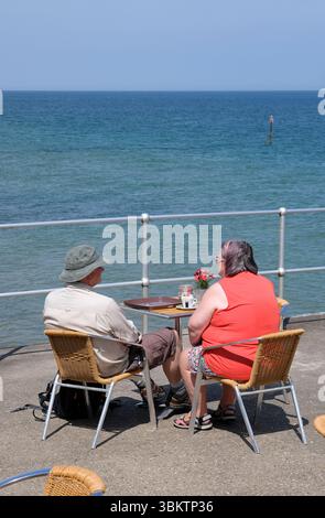 couple sitting at table, sheringham promenade, north norfolk, england Stock Photo