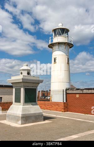 Historical lighthouse Heugh light with adjacent monument and clear blue sky in the background on a sunny day in  hartlepool Stock Photo