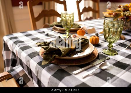 Thanksgiving table setting decorated with pumpkins and golden pear Stock Photo