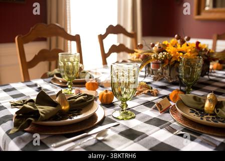 Thanksgiving table setting decorated with pumpkins, pears, and flowers Stock Photo