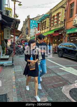 Taipei, Taiwan, Taiwanese Teen Couple, Walking, Shopping on Local Shops, Dihua Old Street, Scene Stock Photo