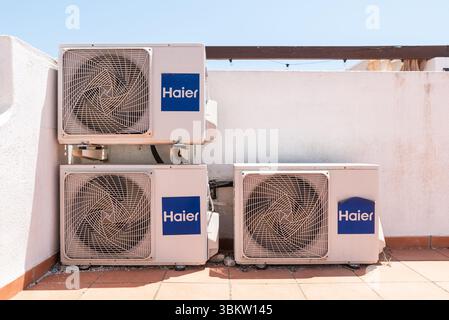 Three Haier external air conditioning units on the solarium of a property in Spain, Europe. Haier Group Corporation is a Chinese multinational Stock Photo