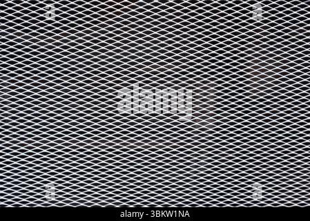 White expanded metal mesh on black background. Stock Photo