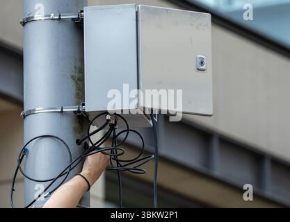 Schwerin, Germany. 23rd June, 2025. An employee of a specialist company lays cables for the new video surveillance system at Marienplatz in the city center. 24 new cameras are being installed on the square, which is known for its high incidence of violent clashes. Credit: Jens Büttner/dpa/Ģ����ý Live News Stock Photo