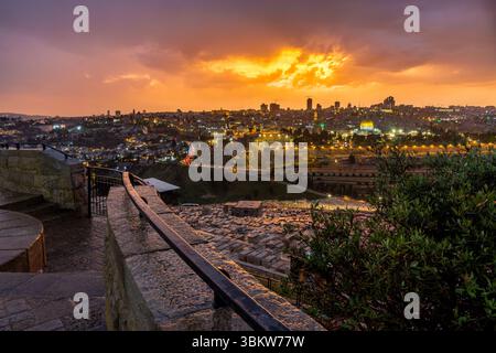 A fiery sunset over the Old City of Jerusalem as seen from the top of the Mount of Olives in Israel Stock Photo