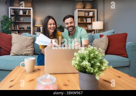 Successful young business people working together in home office. Freelance couple teamwork businessman and businesswoman startup concept video call p Stock Photo