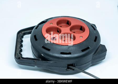 Electrical Long Extension cable cord on reel with remote socket outdoor Stock Photo