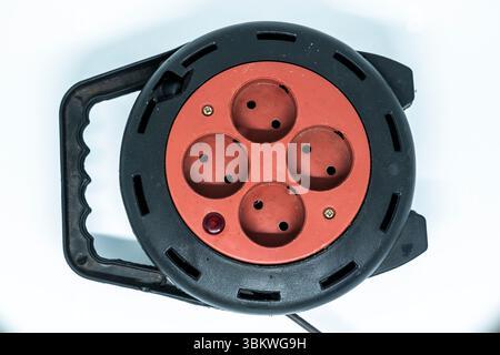 Electrical Long Extension cable cord on reel with remote socket outdoor Stock Photo