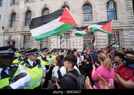 Police block the way of people taking part in a demonstration in central in London in support of Palestine Action. The Home Secretary is preparing to ban Palestine Action following the group's vandalism of two planes at an RAF base, making it a criminal offence to belong to or support Palestine Action. Picture date: Monday June 23, 2025. Stock Photo