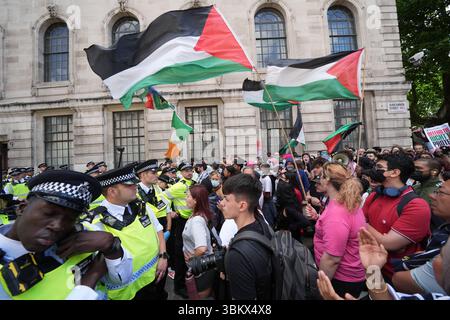 Police block the way of people taking part in a demonstration in central in London in support of Palestine Action. The Home Secretary is preparing to ban Palestine Action following the group's vandalism of two planes at an RAF base, making it a criminal offence to belong to or support Palestine Action. Picture date: Monday June 23, 2025. Stock Photo