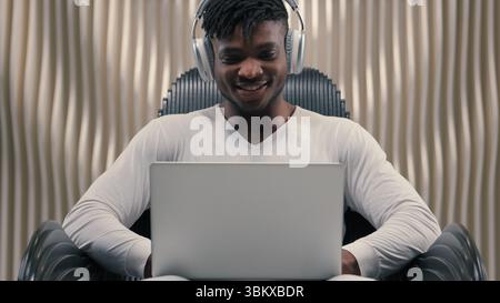 Futurism African American man male programmer developer smiling cyber data guy in white futuristic room indoors cyberspace modern technology wearing Stock Photo