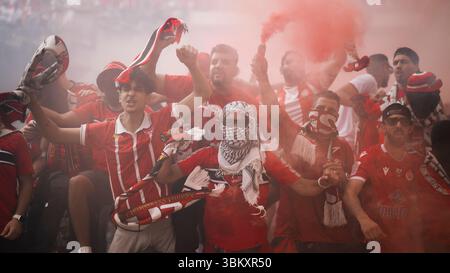 Fans of Wydad AC light flares and smoke bombs as they show their