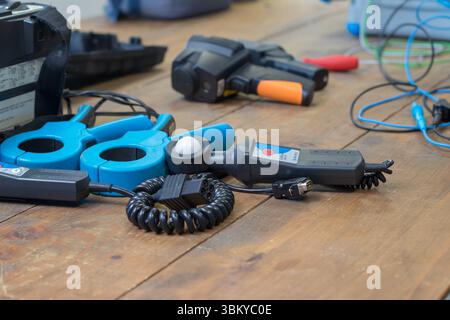 VINKOVCI, CROATIA, 06.20.2018:A closeup view of electronic testing tools and devices arranged on a wooden work surface. Stock Photo