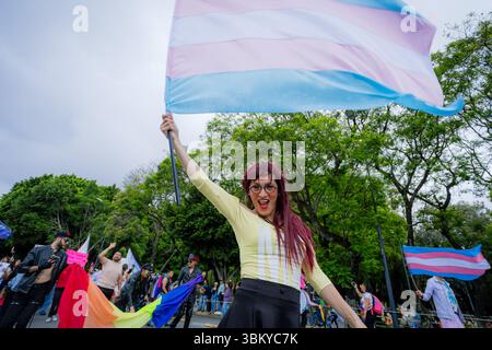 A trans woman raises the transgender flag with pride during the city’s ...