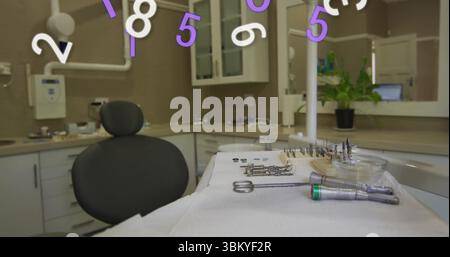 Displaying dental instruments resting on sterile tray in clinic operatory, with floating overlay Stock Photo