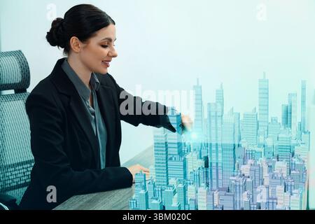 Building information modelling. Woman using holographic projection of city in office Stock Photo