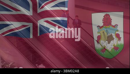 Riding escalator businessmen in dark suits using smartphone and tablet in office lobby Stock Photo