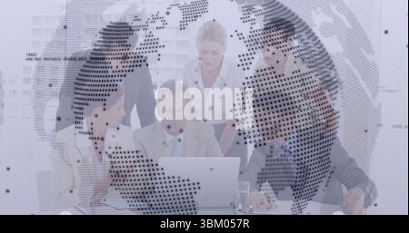 Collaborating business team focusing on laptop during office meeting, with digital globe overlay Stock Photo