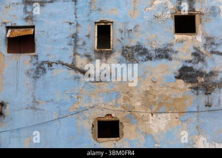 Cuba, Havana. Old Havana wall, peeling blue paint. Vacant windows. Stock Photo