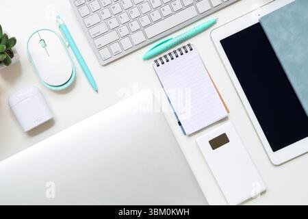 Different gadgets with notebooks on white background Stock Photo