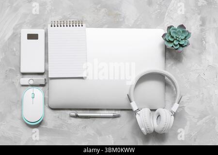 Modern gadgets with notebook on grunge background Stock Photo