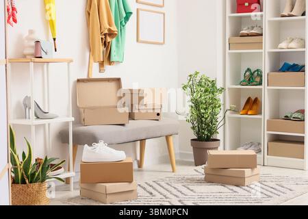 Soft bench with shoe boxes in wardrobe Stock Photo