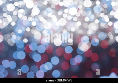 Soft circular lights are creating abstract bokeh pattern in flat design style on dark backdrop Stock Photo