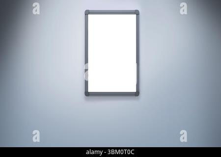 Blank whiteboard with dark gray aluminum frame is hanging on smooth pale gray gradient wall Stock Photo