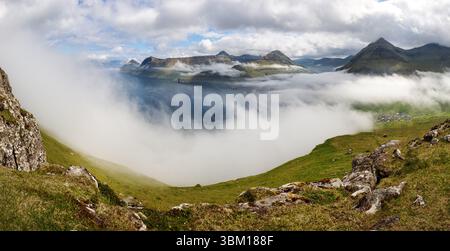 Mountain landscape view over clouds in Fareo islands. Stock Photo