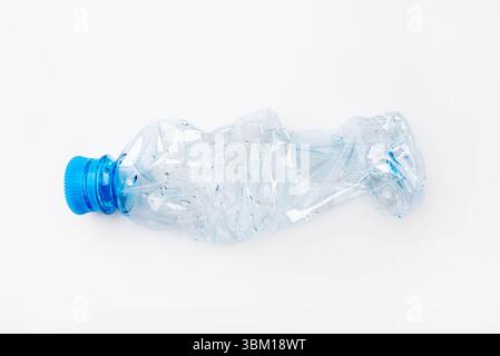 Crumpled empty plastic bottle on a white background Stock Photo