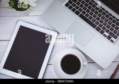 Tablet and laptop on table Stock Photo