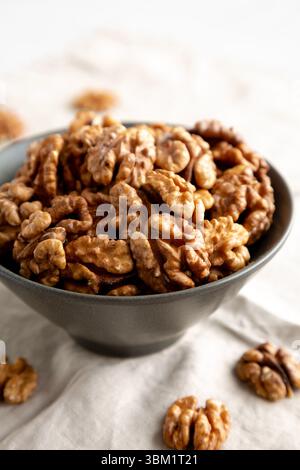 Raw Walnut Halfs in a Bowl, side view. Close-up. Stock Photo