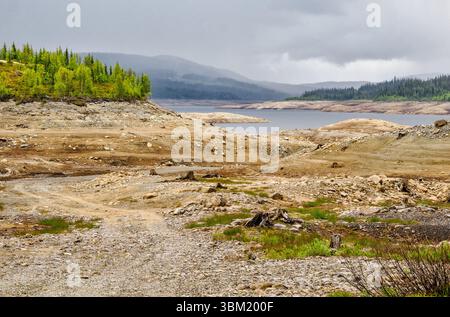 Dried up bed of the Dokke Dam the Dokkfloydammen drained for repairs to the dam wall in the Valdres region of central Norway Stock Photo
