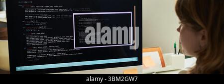 Young Caucasian Woman Developing Neural Network Code on Computer Monitor Stock Photo
