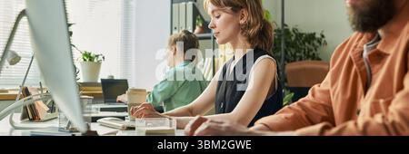 Young Caucasian Woman Developing Neural Network at Computer in Modern Office Stock Photo