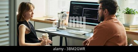 Caucasian Young Woman and Middle Aged Man Discussing Neural Network Development Stock Photo