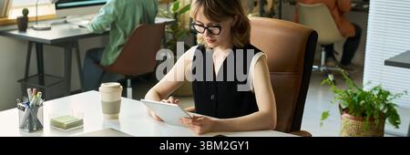 Young Adult Caucasian Woman Analyzing Neural Network Data on Digital Tablet Stock Photo