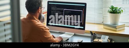 Caucasian Middle Aged Man Writing Neural Network Algorithms on Desktop Computer Stock Photo