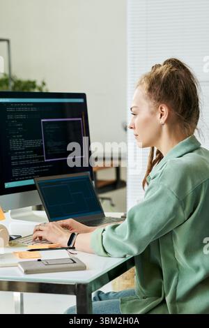 Woman Writing Neural Network Algorithms on Desktop Computer Stock Photo