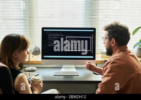 Woman and Man Developing Neural Network Code Stock Photo